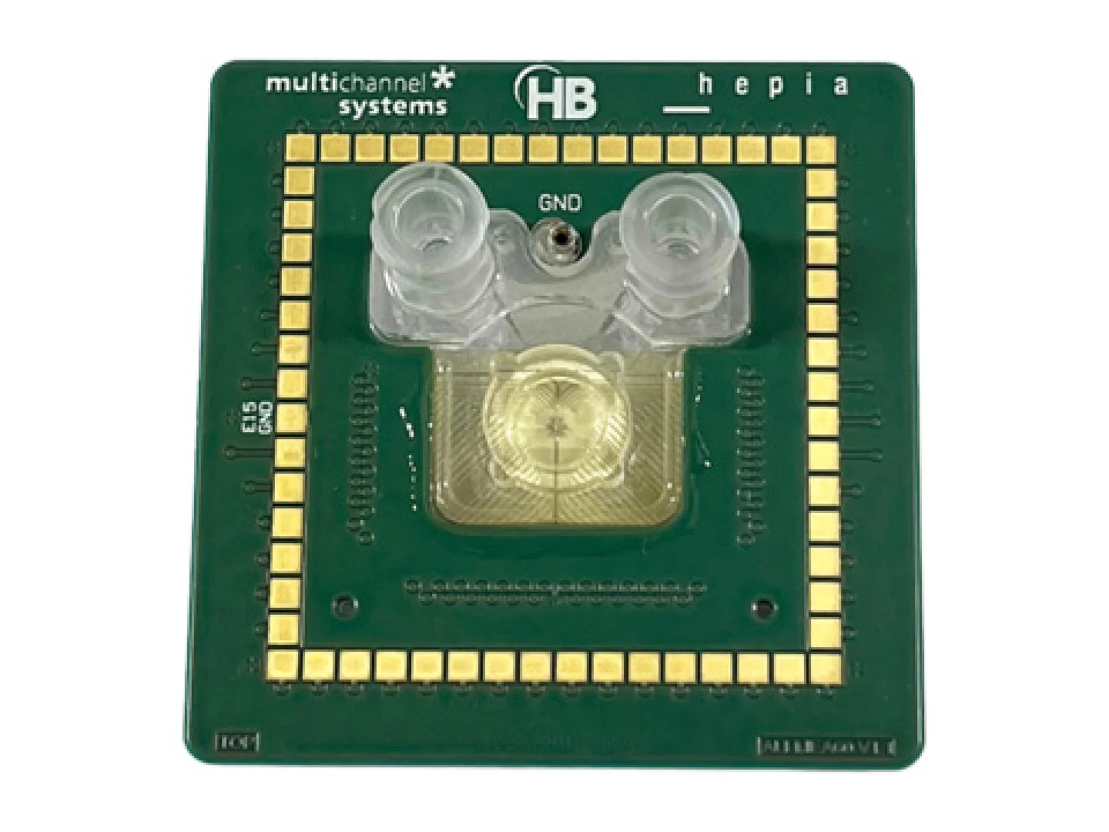 A green circuit board marked multichannel systems with a clear well at its centre