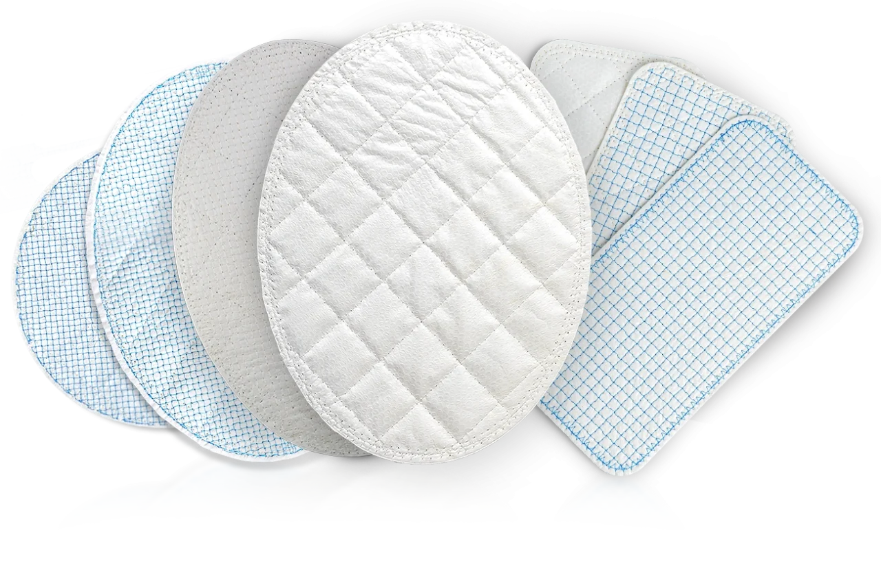 Seven pads of reinforced tissue matrix fanned out, some quilted in a diamond pattern and some stitched with a fine blue grid